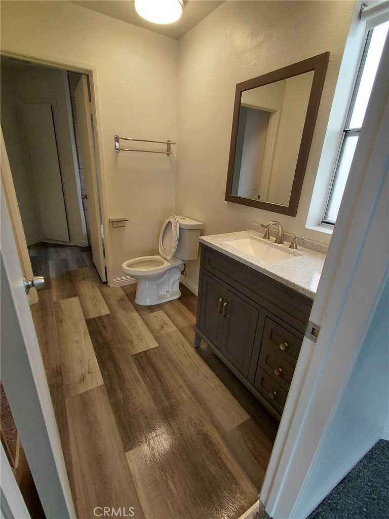 14530 Nautical Lane, Unit 15 Helendale, CA 92342 - Photo 6 of 14 a bathroom with a sink a toilet and mirror