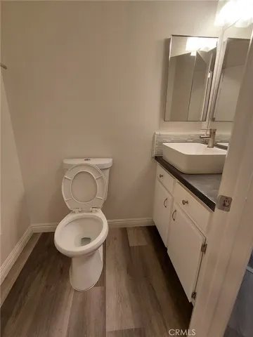 a bathroom with a sink toilet and a mirror