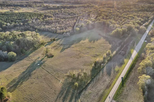 an aerial view of residential houses with city view