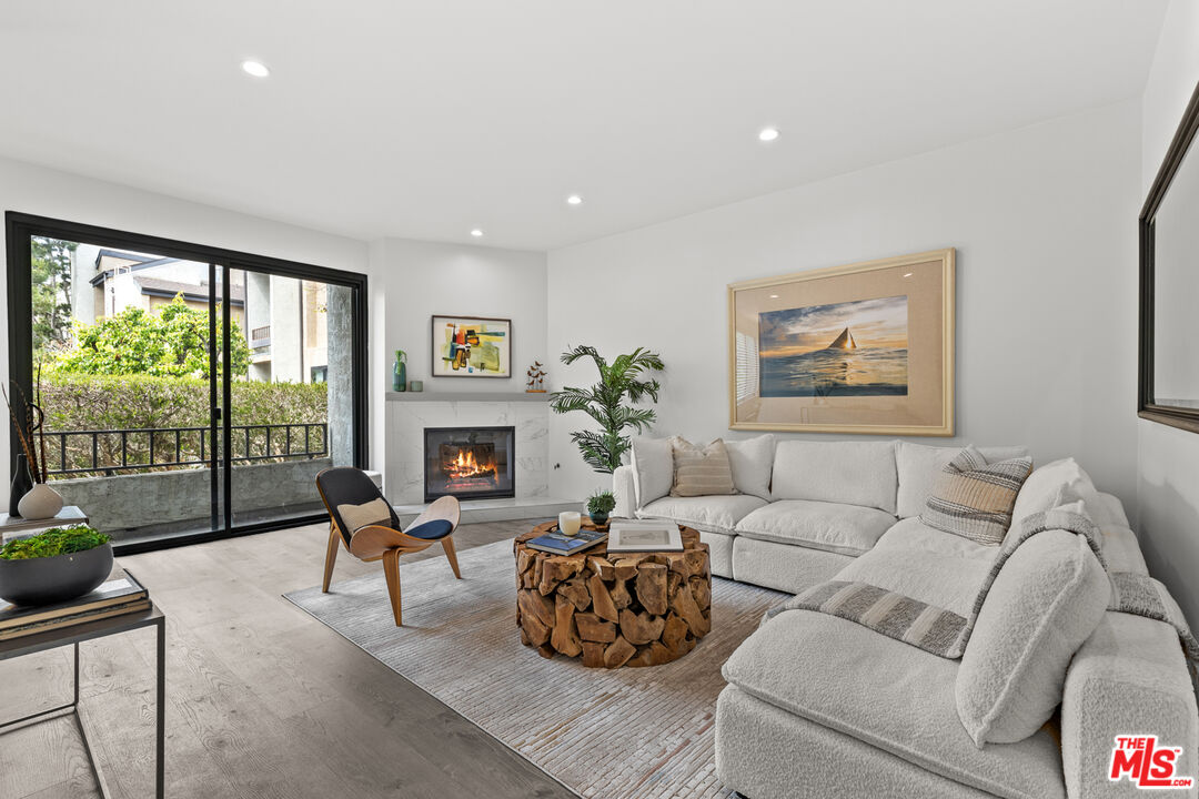 8110 Manitoba Street, Unit 106 Playa del Rey, CA 90293 - Photo 1 of 20 a living room with furniture large window and flat screen tv