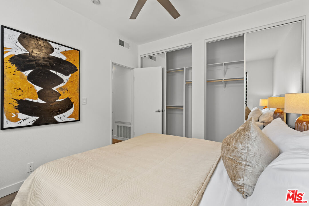 8110 Manitoba Street, Unit 106 Playa del Rey, CA 90293 - Photo 11 of 20 a bedroom with a bed and wall painting