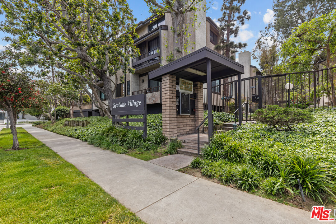 8110 Manitoba Street, Unit 106 Playa del Rey, CA 90293 - Photo 20 of 20 a view of a house with a small yard plants and large tree
