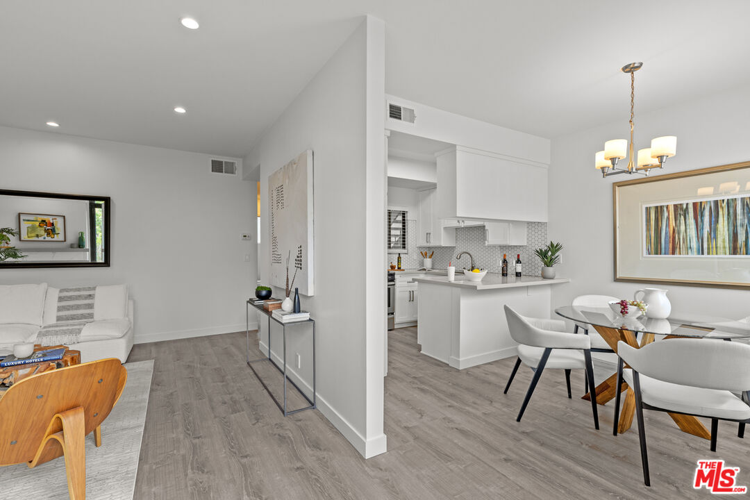 8110 Manitoba Street, Unit 106 Playa del Rey, CA 90293 - Photo 3 of 20 a view of a dining room with furniture window and wooden floor
