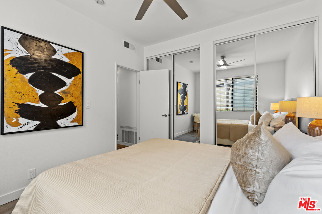 8110 Manitoba Street, Unit 106 Playa del Rey, CA 90293 - Photo 10 of 20 a bedroom with a bed and wall painting