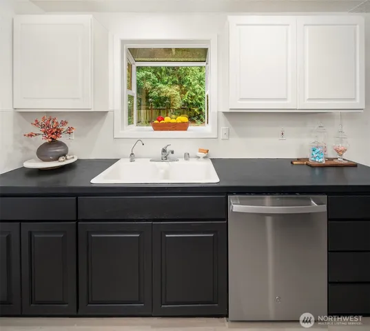 a kitchen with stainless steel appliances granite countertop a sink stove and cabinets