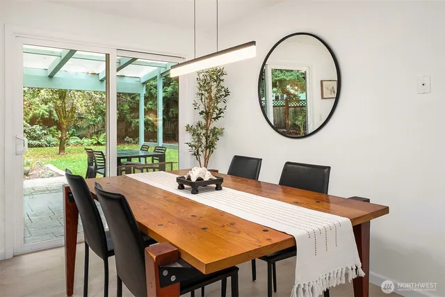 a dining room with furniture a mirror and a window