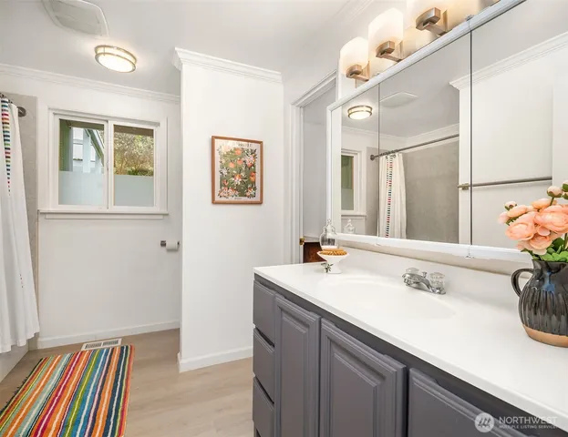 a bathroom with a sink a vanity and a mirror