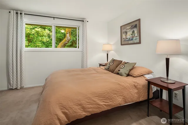 a bedroom with a bed and a lamp on table