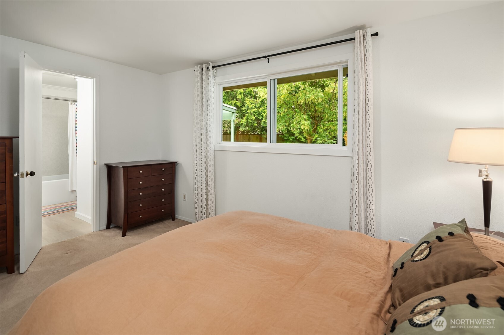 18304 McLean Road Southwest Vashon, WA 98070 - Photo 18 of 36 a bedroom with a bed and a window