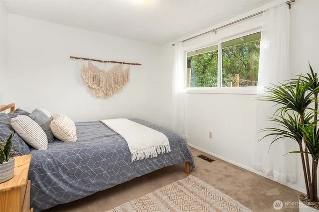 a bedroom with a bed and a window