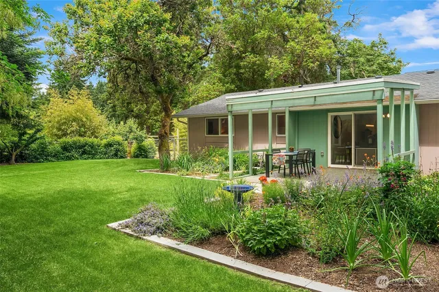 a front view of house with yard and green space