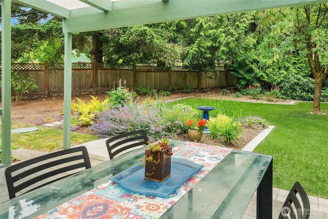 a view of a lake from a living space with furniture