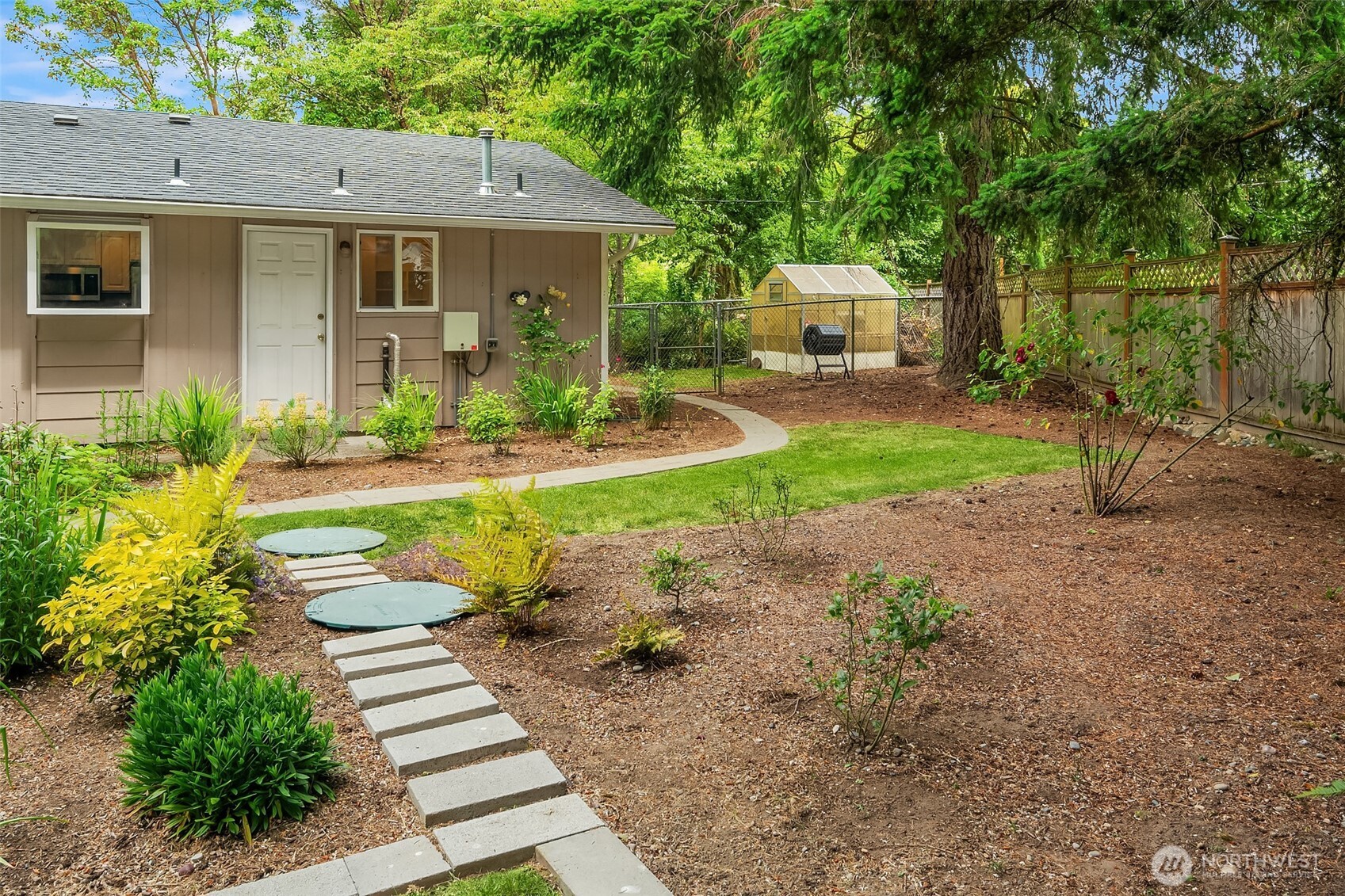 18304 McLean Road Southwest Vashon, WA 98070 - Photo 27 of 36 a front view of a house with garden