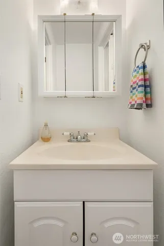 a bathroom with a sink and cabinets