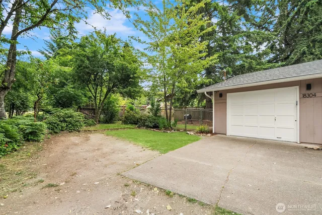 a view of a house with a yard and garage
