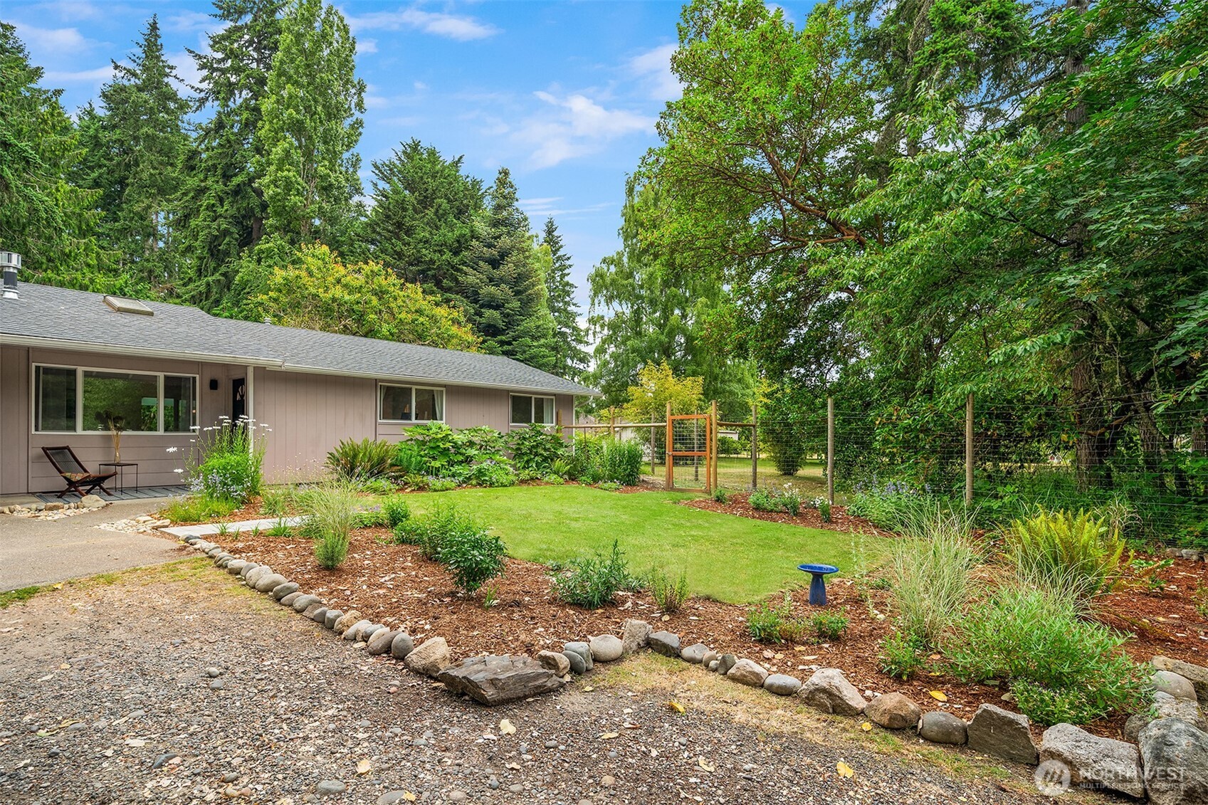 18304 McLean Road Southwest Vashon, WA 98070 - Photo 4 of 36 a front view of a house with garden