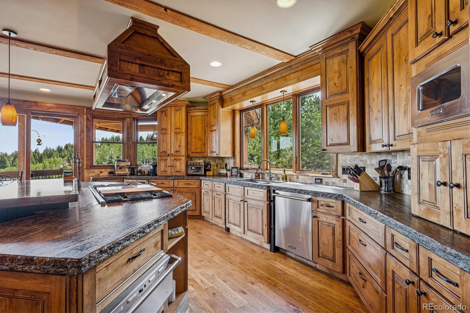 477 West Meadow Road Evergreen, CO 80439 - Photo 14 of 50 a kitchen with sink a stove and cabinets