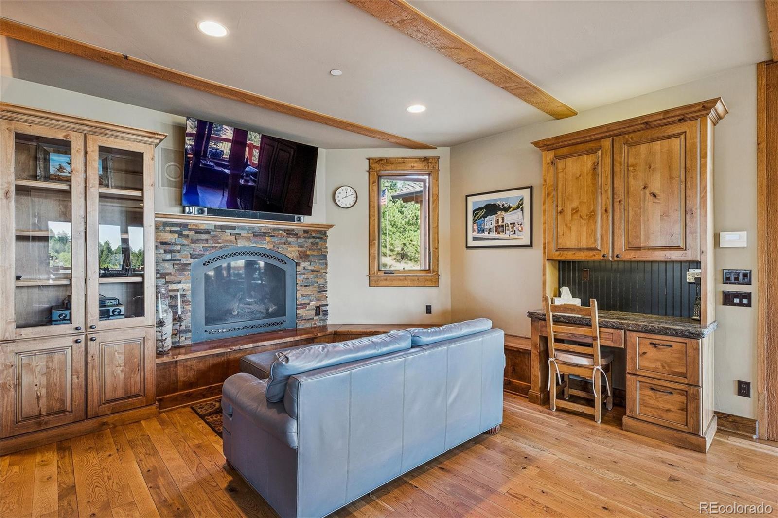 477 West Meadow Road Evergreen, CO 80439 - Photo 16 of 50 a living room with furniture a flat screen tv and a fireplace