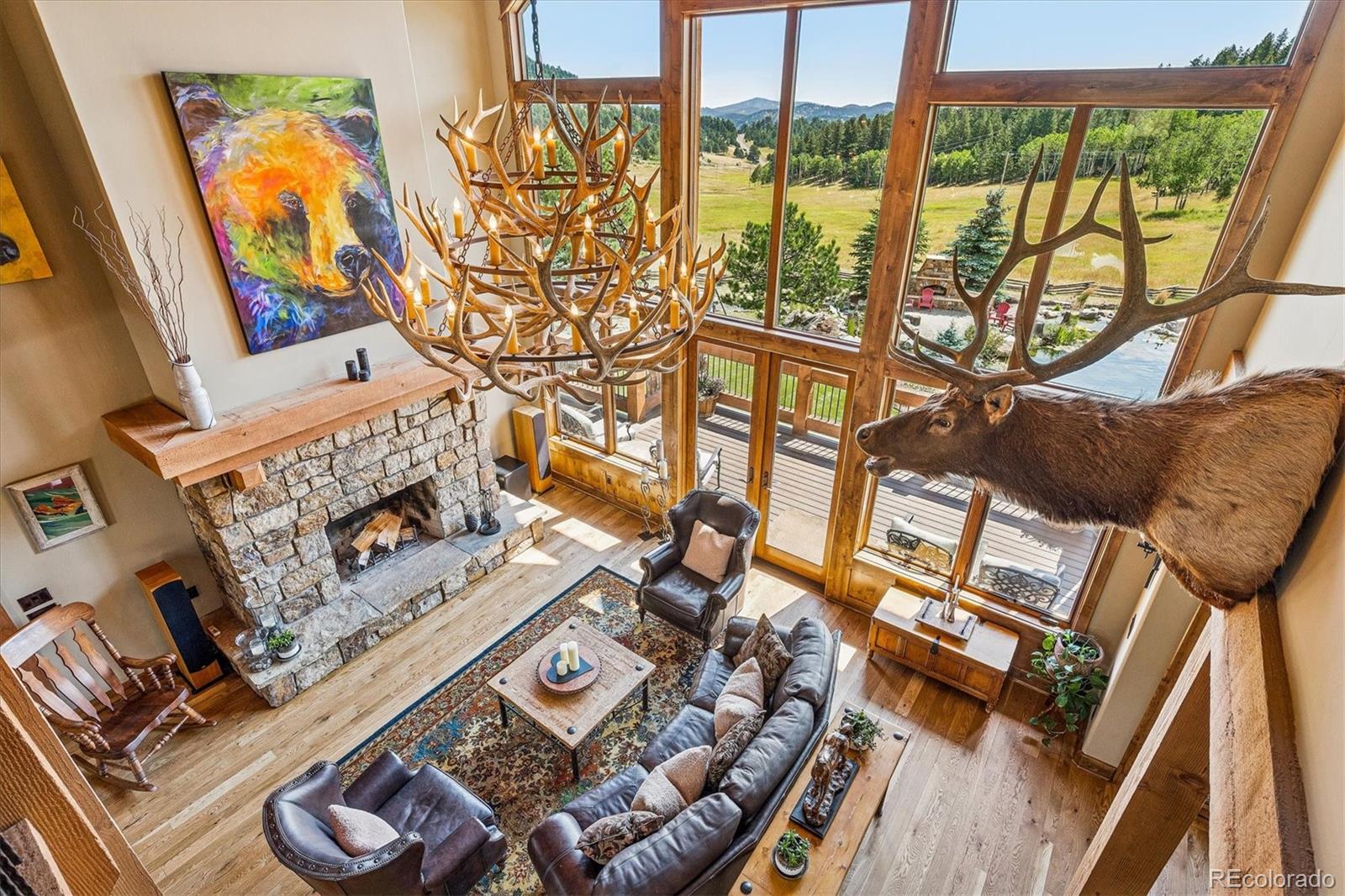 477 West Meadow Road Evergreen, CO 80439 - Photo 26 of 50 a living room with furniture and a floor to ceiling window