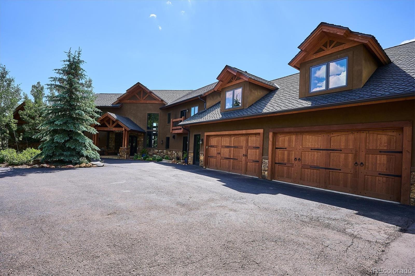 477 West Meadow Road Evergreen, CO 80439 - Photo 3 of 50 a view of a house with a yard and garage