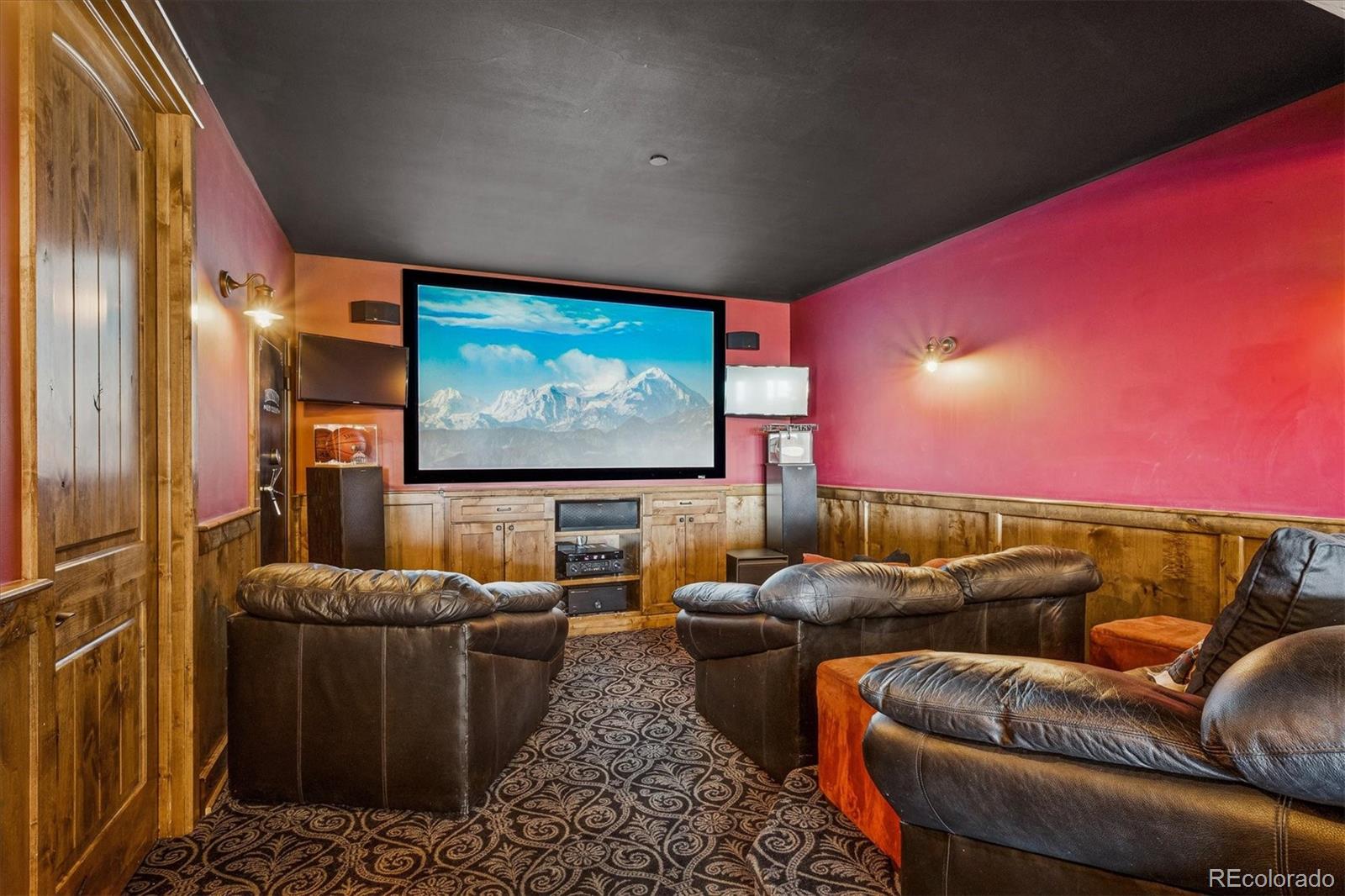 477 West Meadow Road Evergreen, CO 80439 - Photo 32 of 50 a media room with lots of chairs and a projector