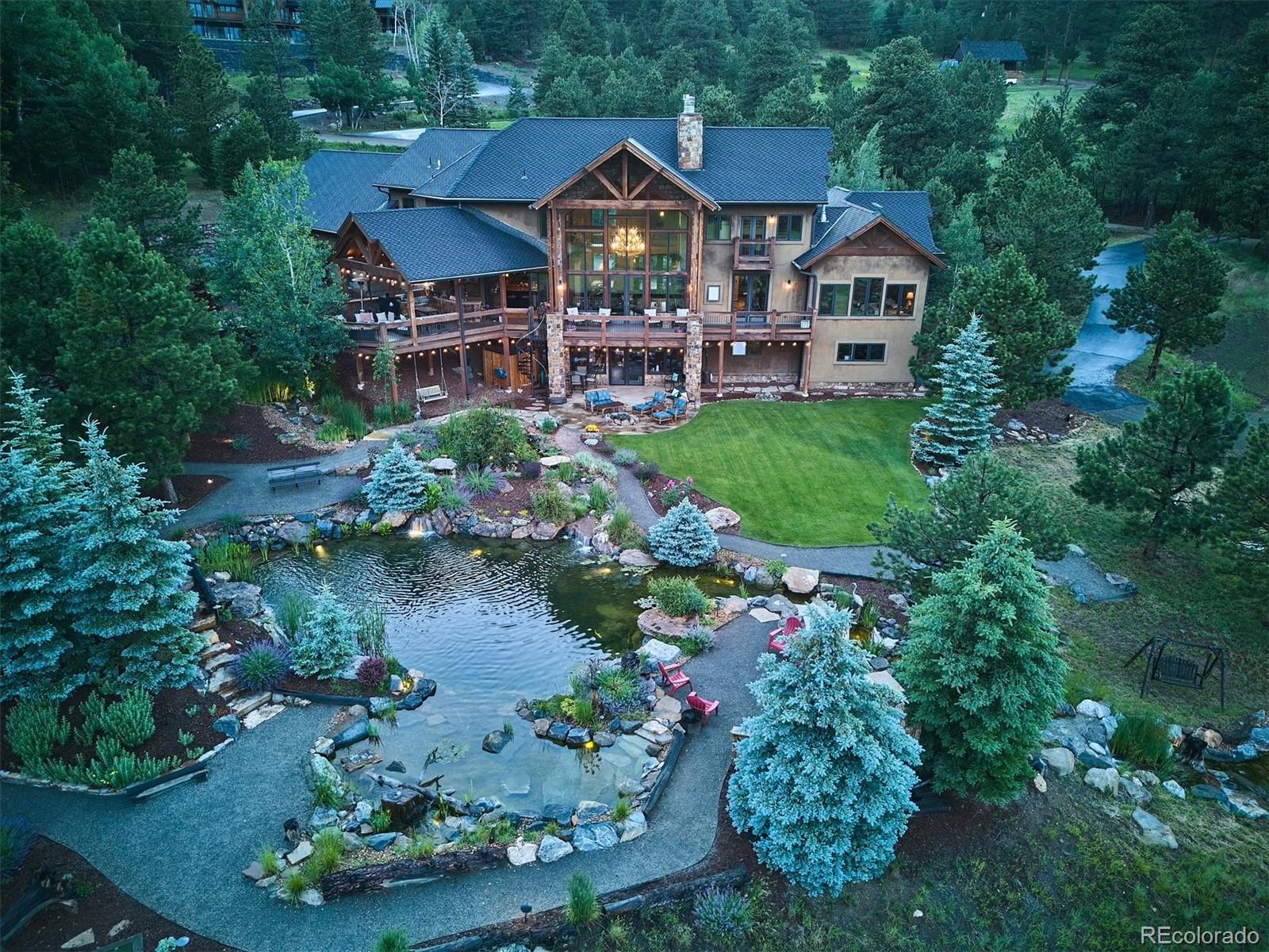 477 West Meadow Road Evergreen, CO 80439 - Photo 39 of 50 an aerial view of a house with a yard and lake view