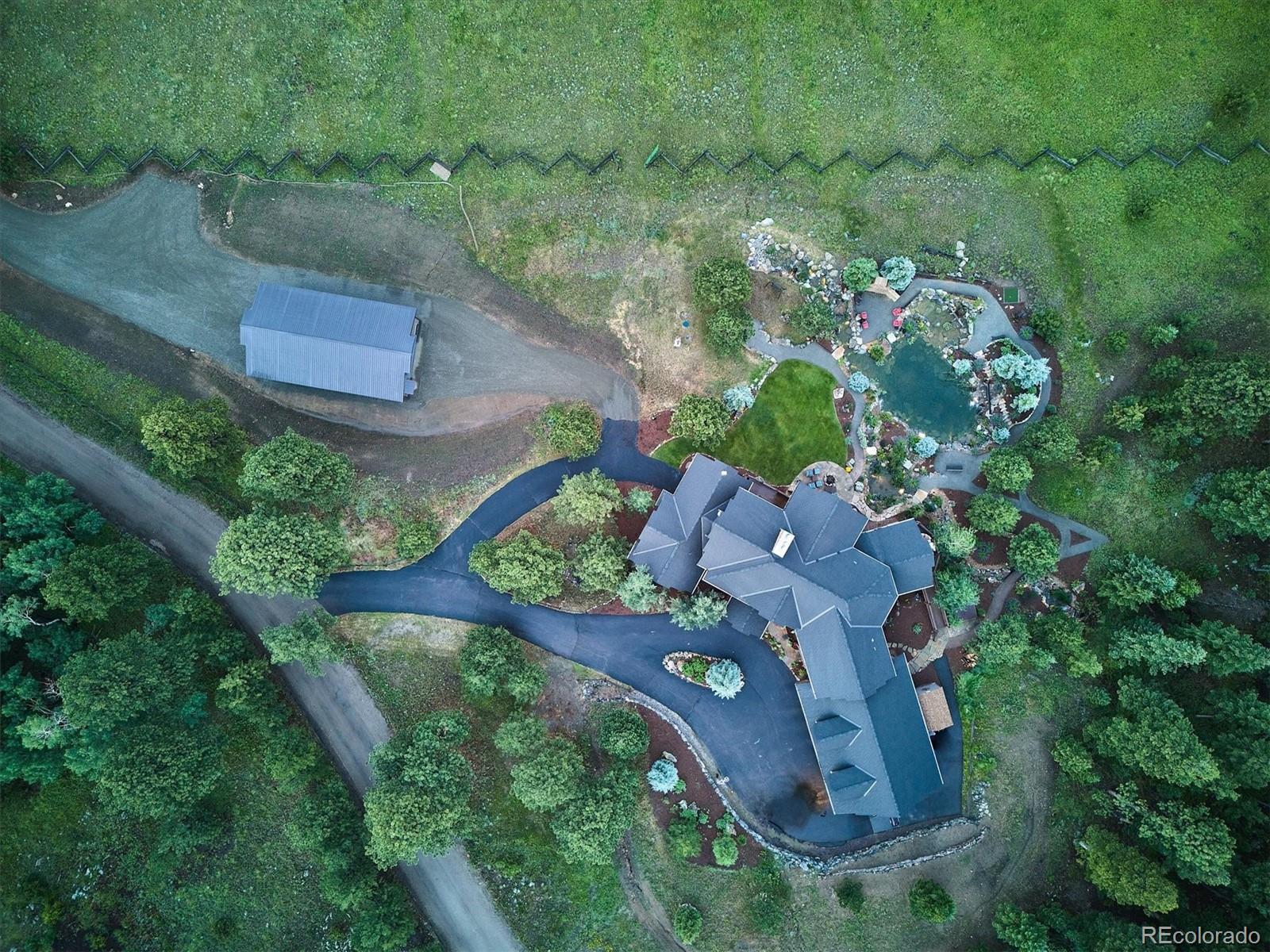 477 West Meadow Road Evergreen, CO 80439 - Photo 40 of 50 an aerial view of a house with a yard