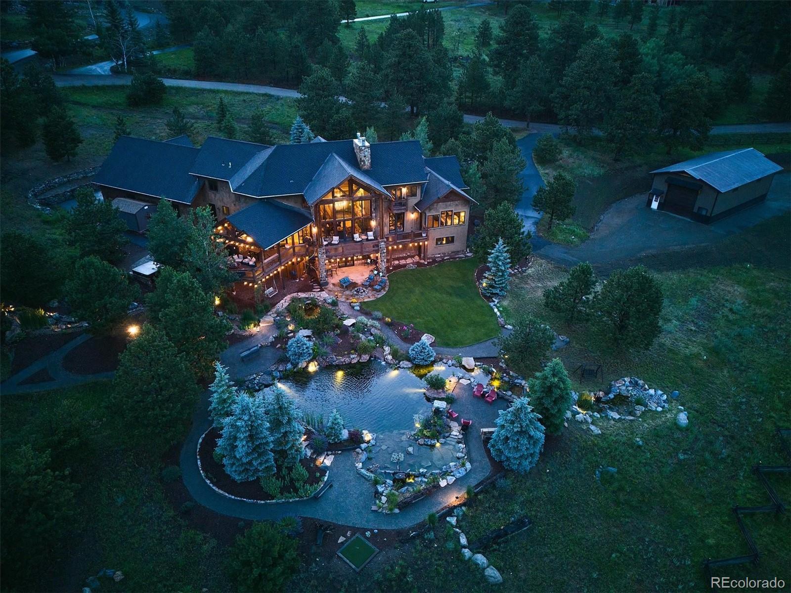 477 West Meadow Road Evergreen, CO 80439 - Photo 41 of 50 an aerial view of a house with garden space lake and outdoor seating