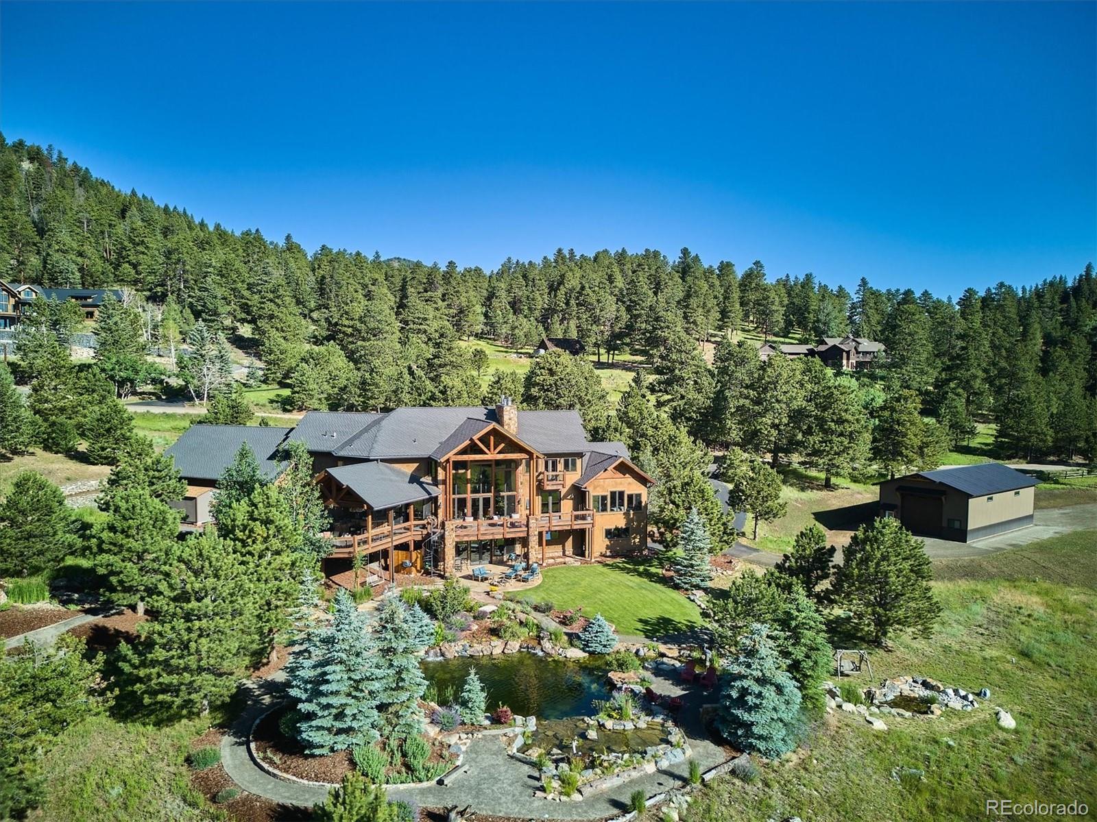 477 West Meadow Road Evergreen, CO 80439 - Photo 42 of 50 a view of a garden with a house
