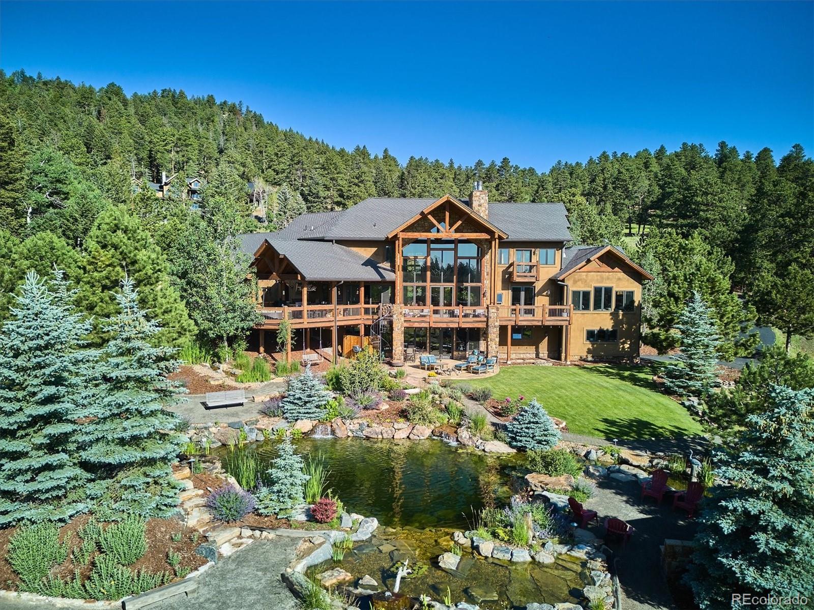 477 West Meadow Road Evergreen, CO 80439 - Photo 43 of 50 a front view of a house with a yard
