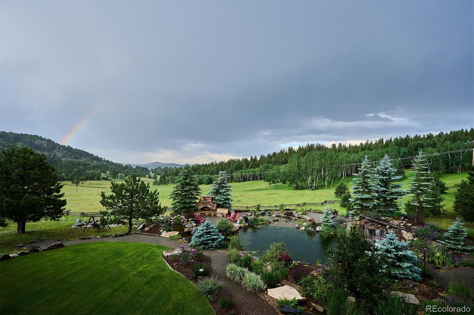 477 West Meadow Road Evergreen, CO 80439 - Photo 46 of 50 a view of a lush green outdoor space with a lake view