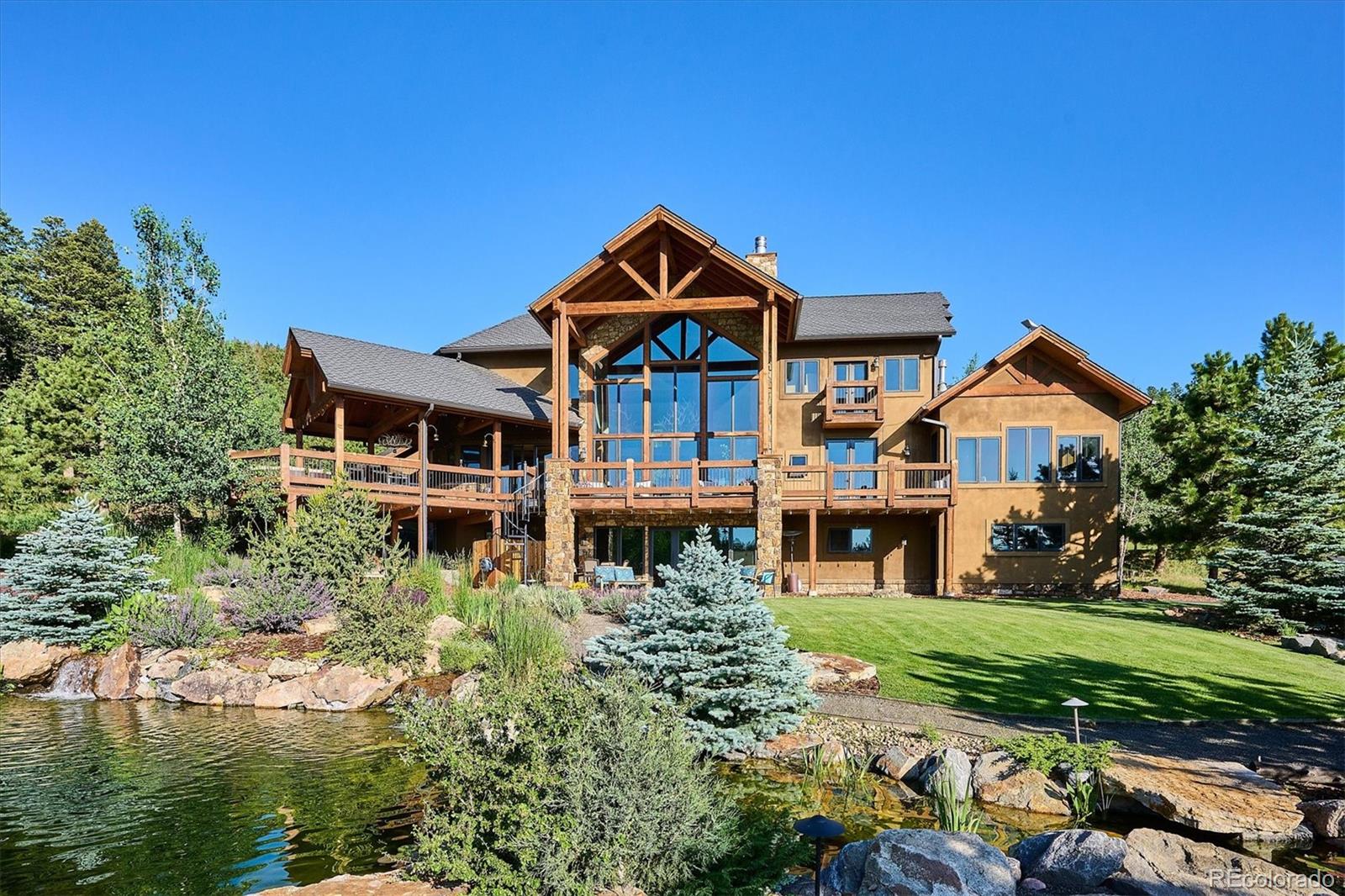 477 West Meadow Road Evergreen, CO 80439 - Photo 47 of 50 a front view of a house with garden