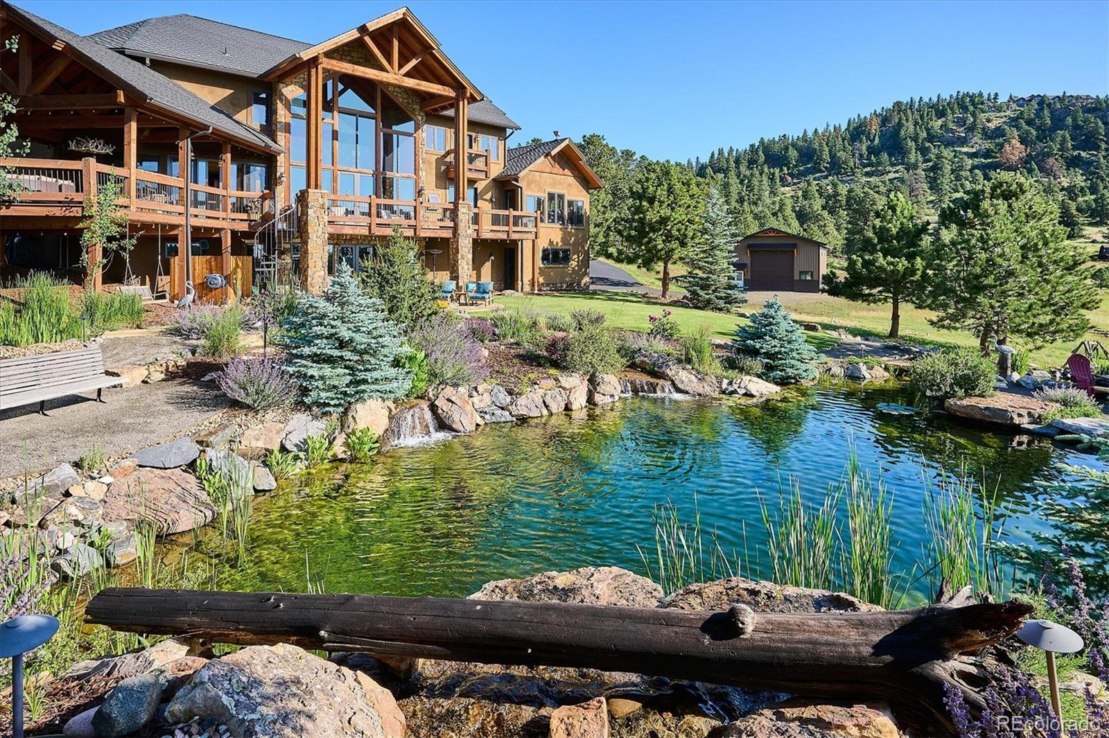 477 West Meadow Road Evergreen, CO 80439 - Photo 48 of 50 a view of a lake with a house in the background