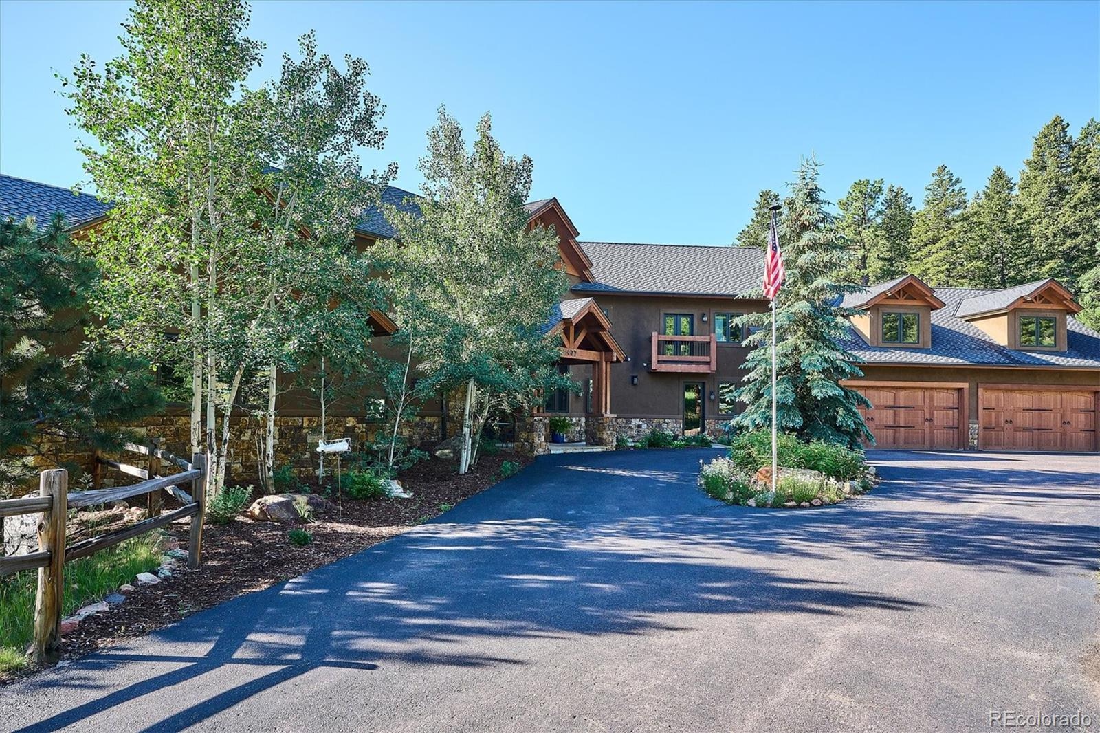 477 West Meadow Road Evergreen, CO 80439 - Photo 49 of 50 a front view of a house with garden
