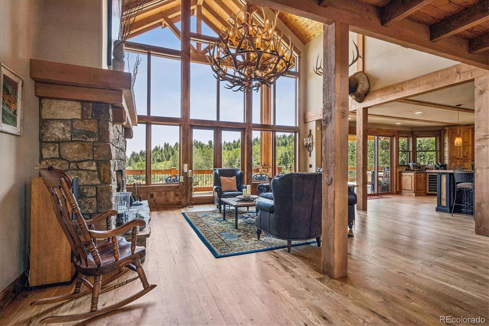 477 West Meadow Road Evergreen, CO 80439 - Photo 9 of 50 a living room with furniture and a floor to ceiling window