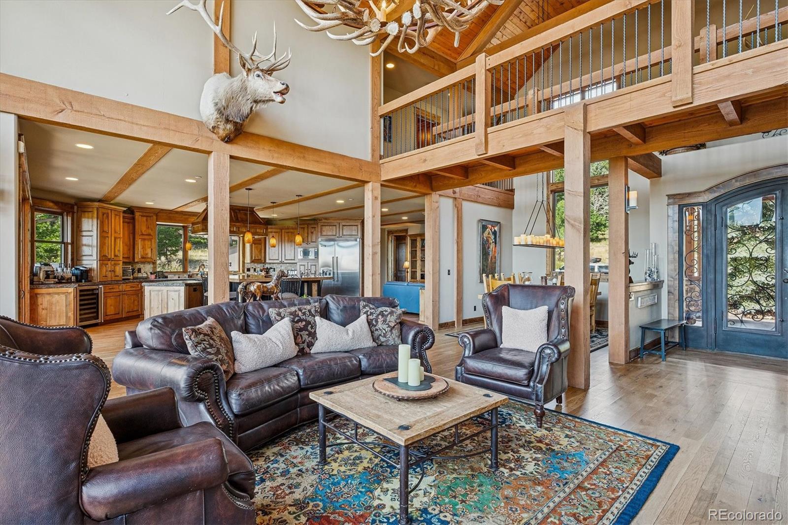 477 West Meadow Road Evergreen, CO 80439 - Photo 10 of 50 a living room with furniture a rug and a chandelier