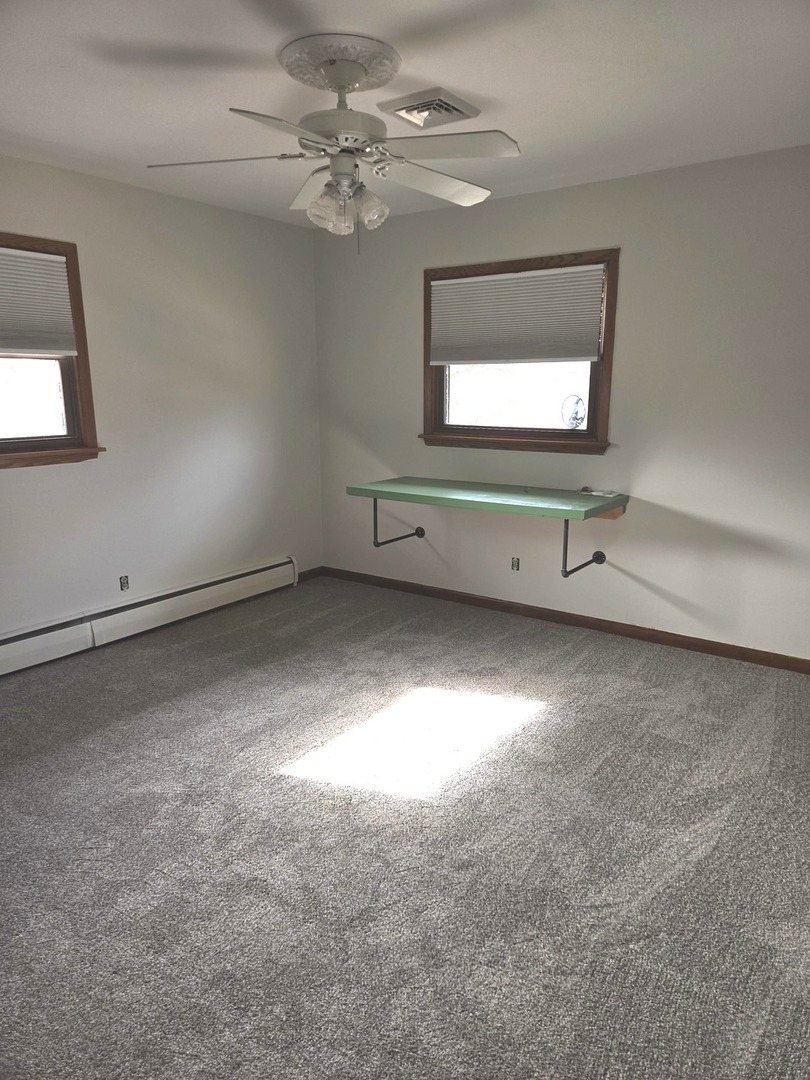 1309 Crest Lane Rochelle, IL 61068 - Photo 15 of 18 an empty room with windows and fan