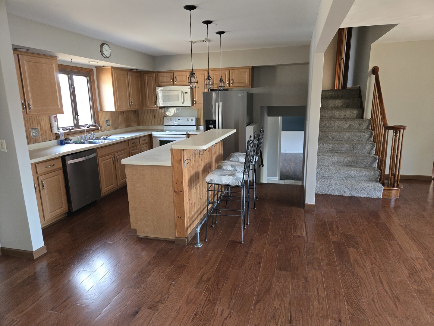 1309 Crest Lane Rochelle, IL 61068 - Photo 4 of 18 a kitchen with stainless steel appliances granite countertop a refrigerator a sink dishwasher a stove and a dining table with wooden floor