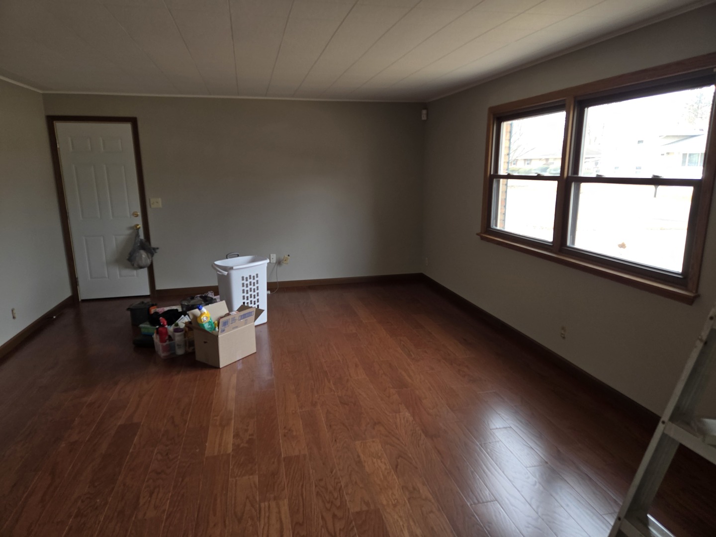 1309 Crest Lane Rochelle, IL 61068 - Photo 7 of 18 an empty room with wooden floor and windows