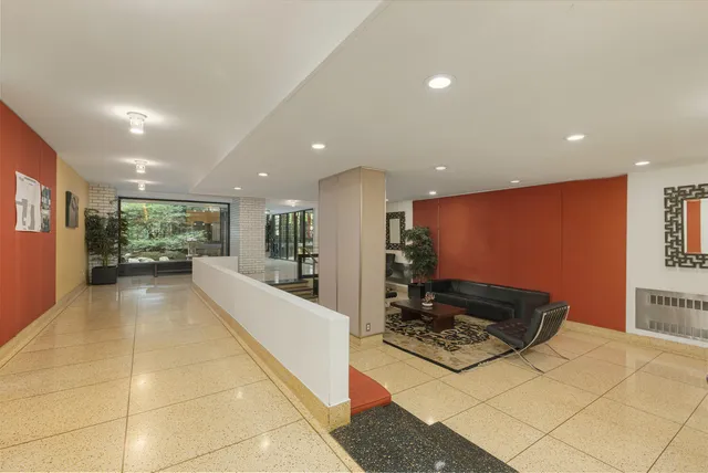 a view of a house with a tree and wooden fence