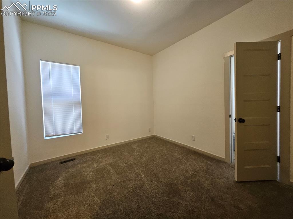 1138 Pine Street Pueblo, CO 81004 - Photo 13 of 22 an empty room with windows and closet