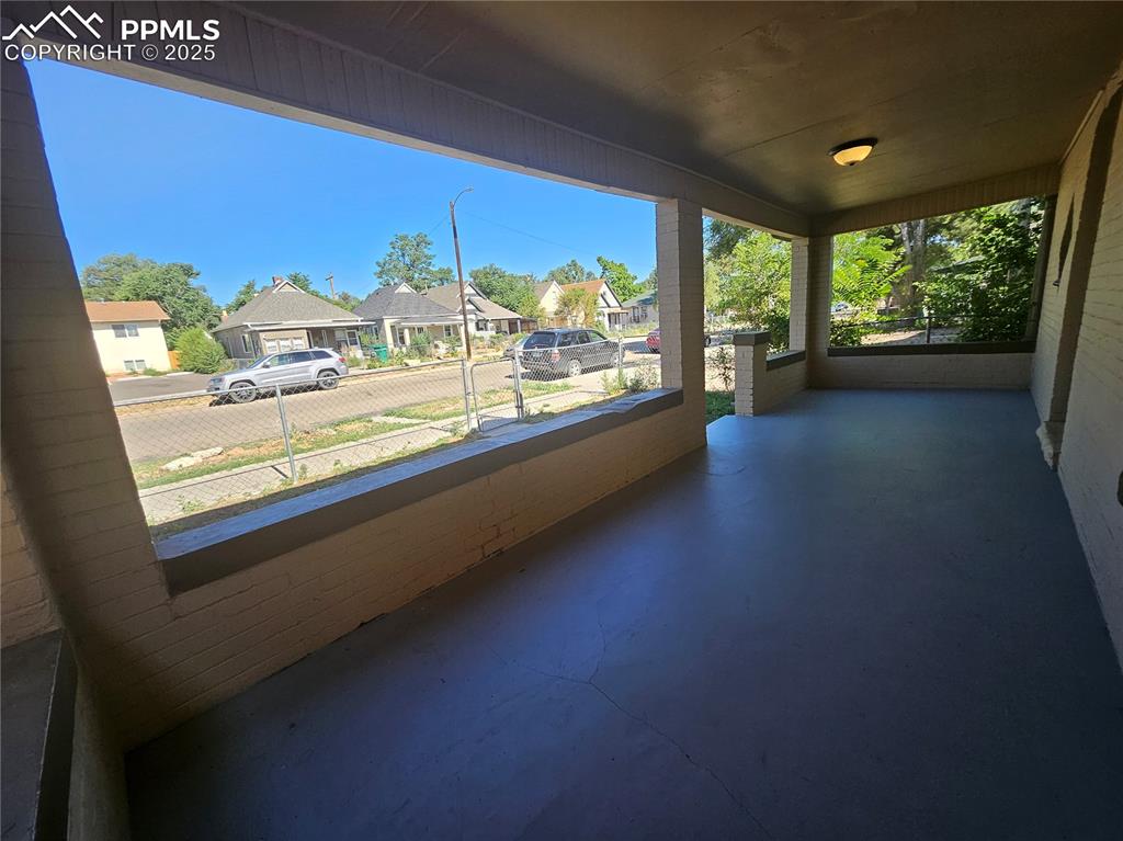1138 Pine Street Pueblo, CO 81004 - Photo 4 of 22 wooden floor in an empty room with a large window