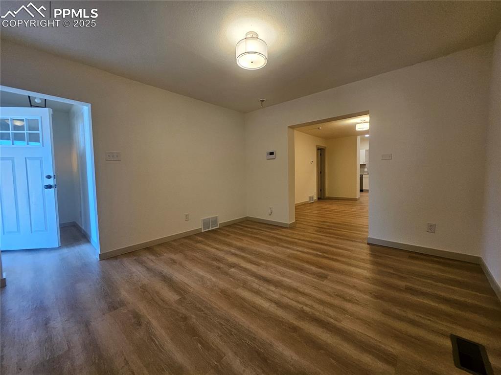 1138 Pine Street Pueblo, CO 81004 - Photo 6 of 22 a view of an empty room with wooden floor