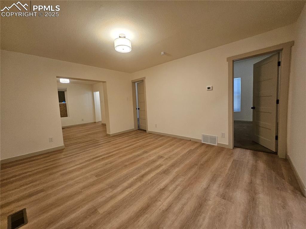 1138 Pine Street Pueblo, CO 81004 - Photo 8 of 22 a view of an empty room and wooden floor