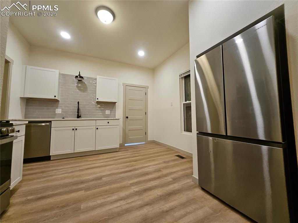 1138 Pine Street Pueblo, CO 81004 - Photo 10 of 22 a kitchen with stainless steel appliances a refrigerator sink and cabinets
