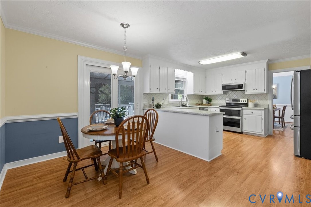 10330 Christina Road Chesterfield, VA 23832 - Photo 16 of 39 a kitchen with a dining table chairs and refrigerator