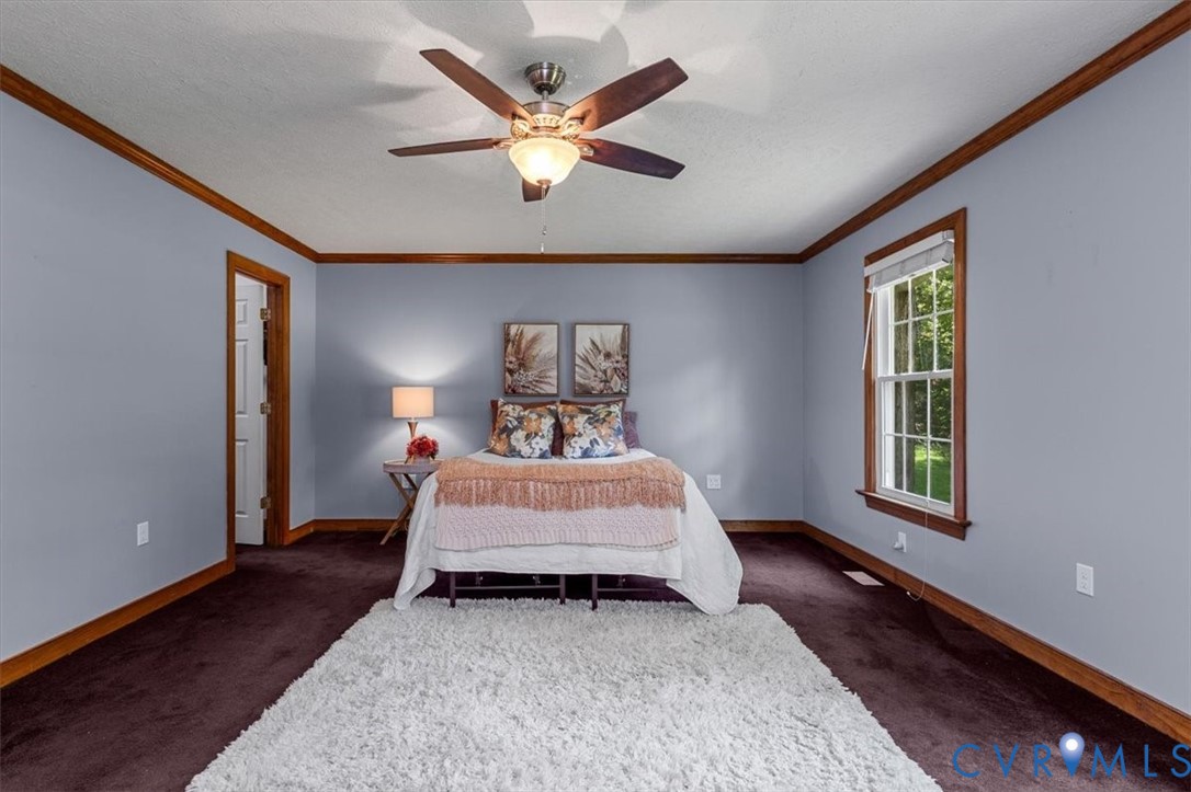 10330 Christina Road Chesterfield, VA 23832 - Photo 9 of 39 a bed sitting in a spacious bedroom next to a window