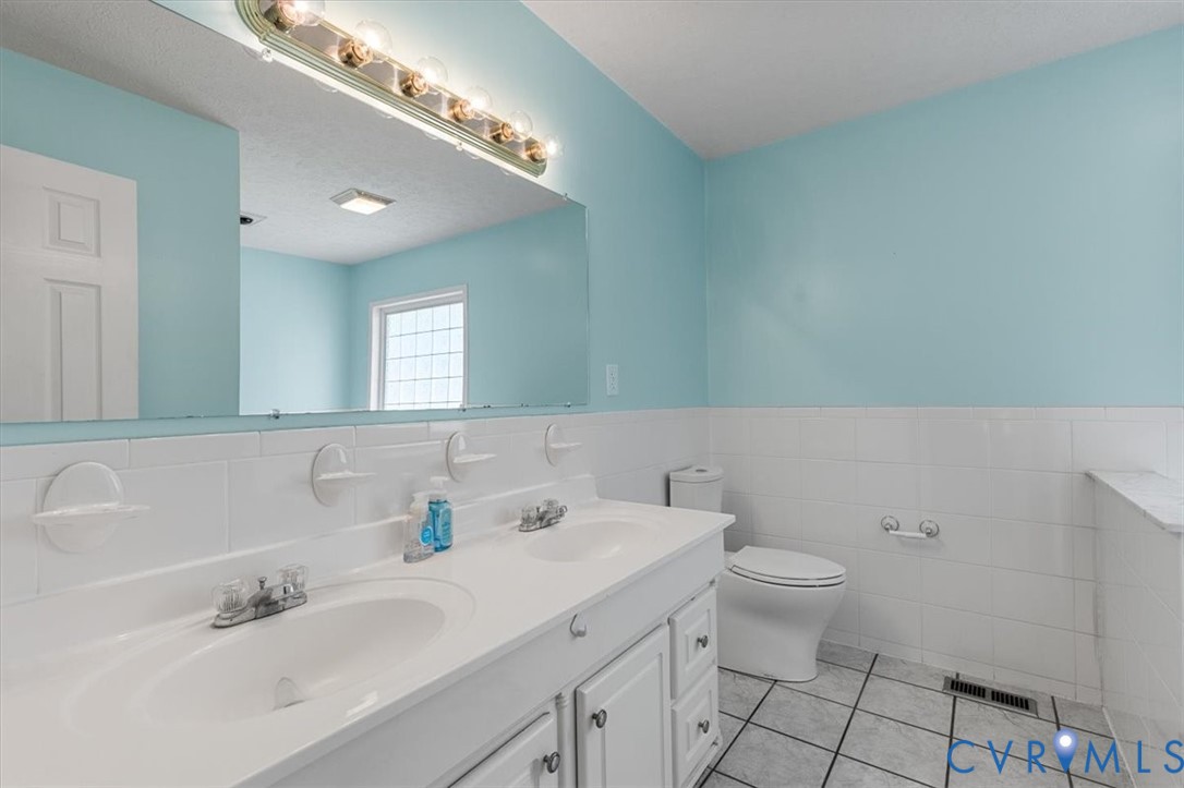 10330 Christina Road Chesterfield, VA 23832 - Photo 10 of 39 a bathroom with a sink mirror and toilet