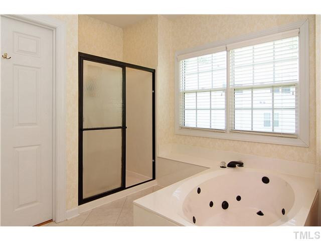 114 Jersey Ridge Road Cary, NC 27518 - Photo 13 of 21 The jetted garden tub is the perfect place to unwind after a hard day. Adjacent to the master bath is a beautiful custom closet, complete with hardwood floors and custom shelving. Master Bath/Spa
