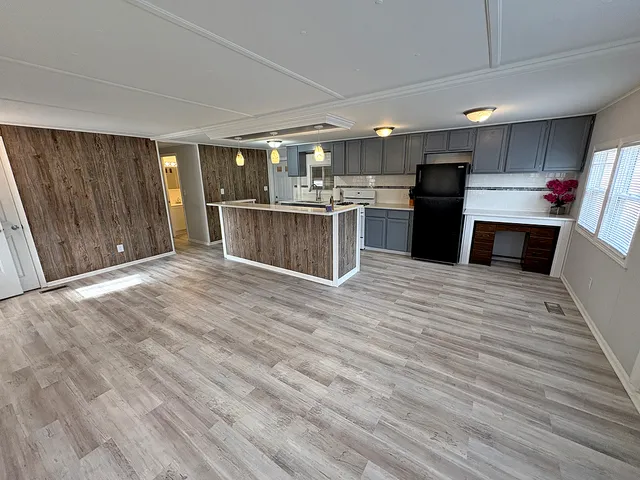 a kitchen with stainless steel appliances kitchen island wooden cabinets and granite counter tops
